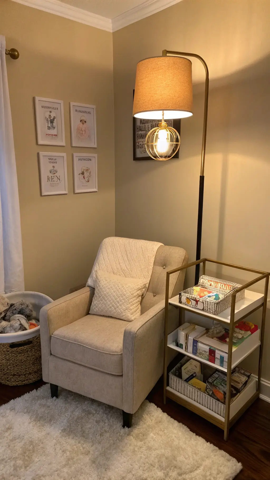 A cozy nursery corner at night, dimly lit by a warm LED floor lamp. An oatmeal linen glider sits beside a brass side table, with an organized caddy holding feeding essentials. A soft sheepskin rug lies underfoot against a warm greige wall, creating a serene midnight feeding station.