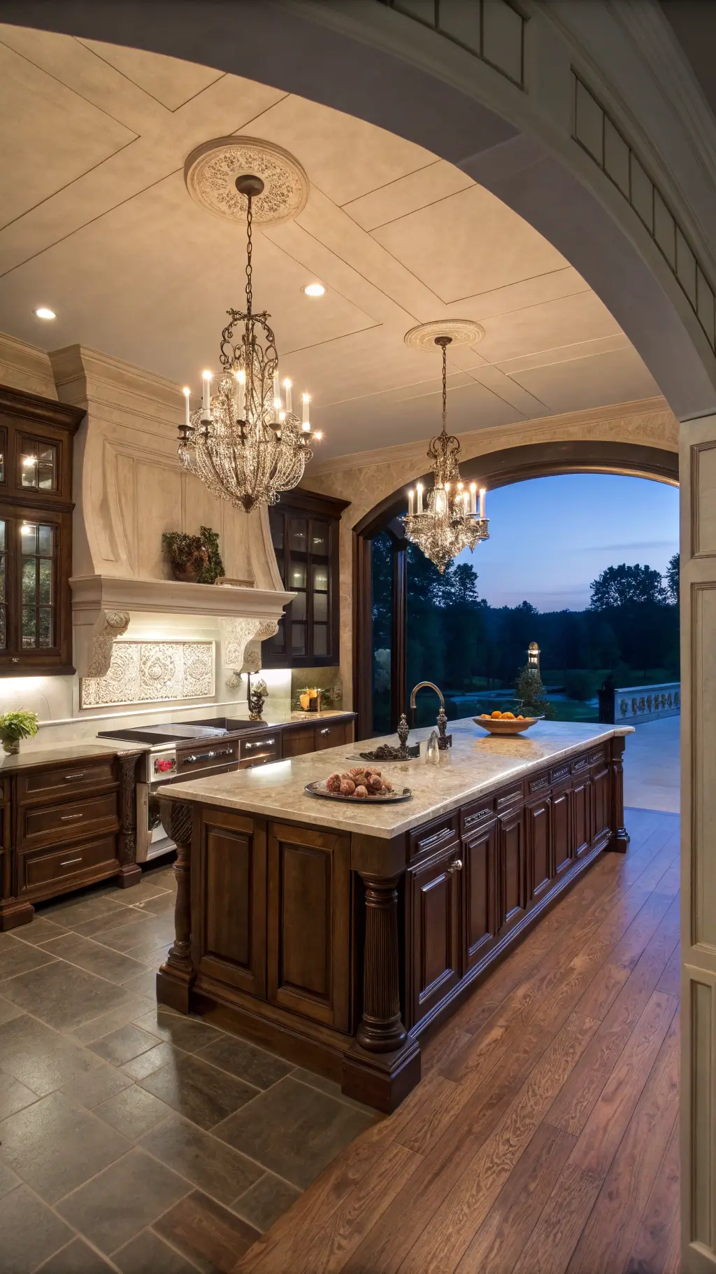 Luxurious grand kitchen with dark walnut and mahogany cabinetry, quartzite countertops, crystal chandeliers, and a butler's pantry visible through an archway.