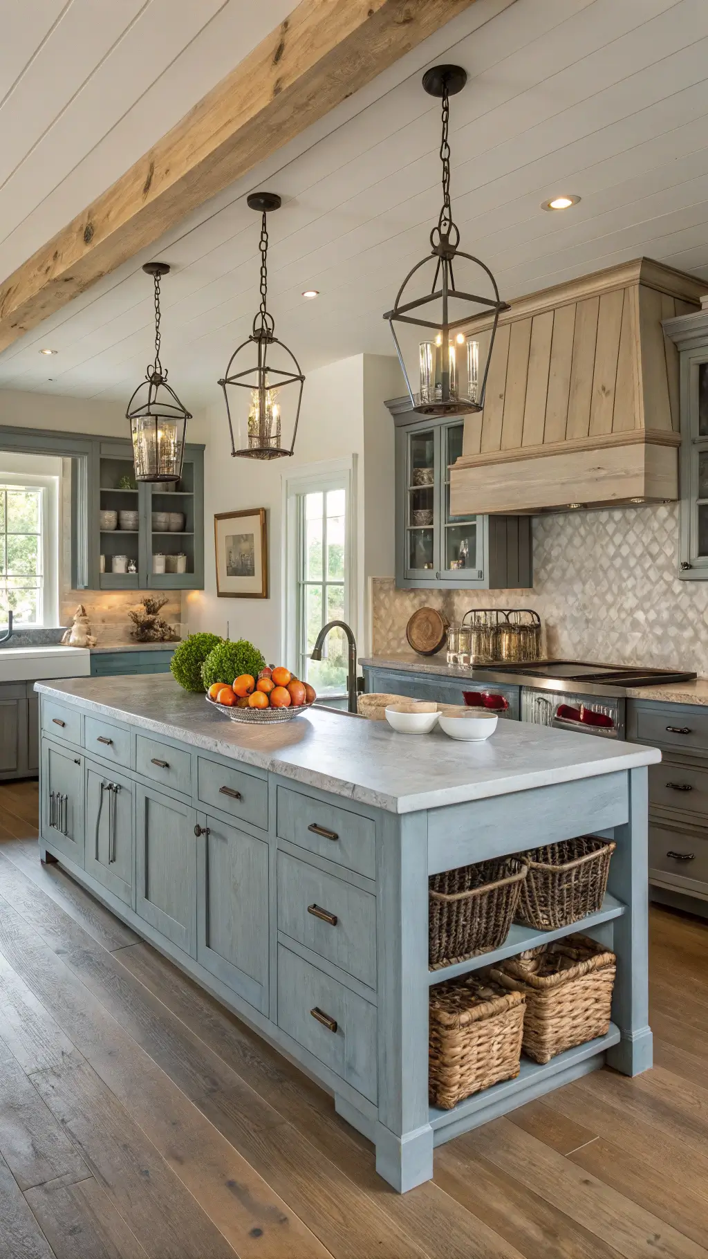 Spacious 16x18ft modern farmhouse kitchen at sunrise, featuring weathered blue-grey cabinets with bin pulls, reclaimed wood island with zinc top, beamed ceiling, vintage canisters, ironstone collection, and fresh market produce under soft diffused morning light.