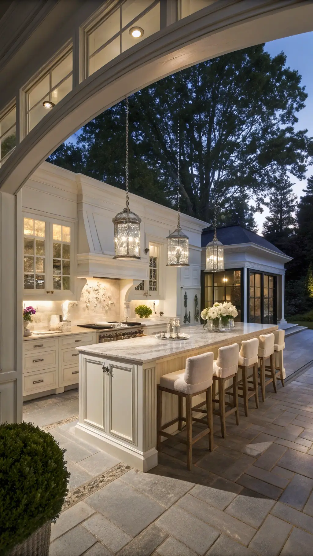Elegant 16x20ft kitchen with white oak cabinets, marble island, crystal pendants, and glass-front displays, styled with hydrangeas and silver decor.